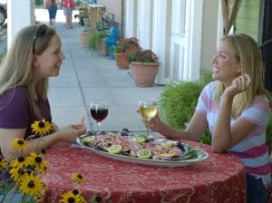 Two women enjoying shrimp and wine in Apalachicola