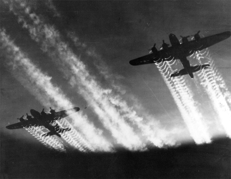 Two B-17 Flying Fortresses' vapor trails light up the night sky over Eastern Europe. Public Domain, U.S. Air Force Photo
